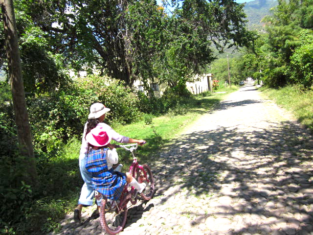 Woman with a Child Riding a Bike in West AJijic