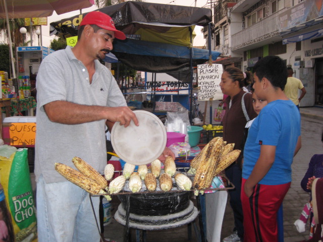 Man Selling Grilled Corn on the Street