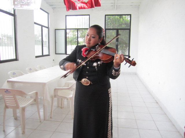 Woman Mariachi, Tuning up her Violin