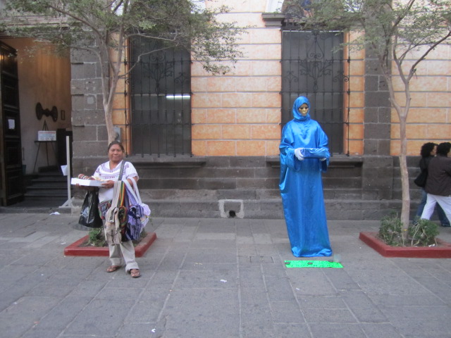 Woman next to blue man statue