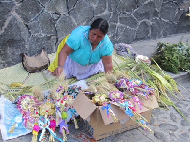 Woman selling palm religious symbols