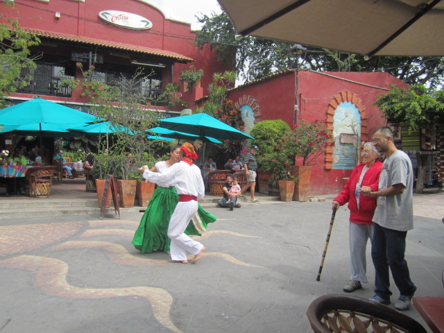 Dancing couple and old woman walking