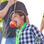 Boy eating apple from string