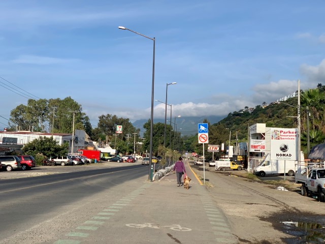 Woman walking dog on Ciclopista Riberas